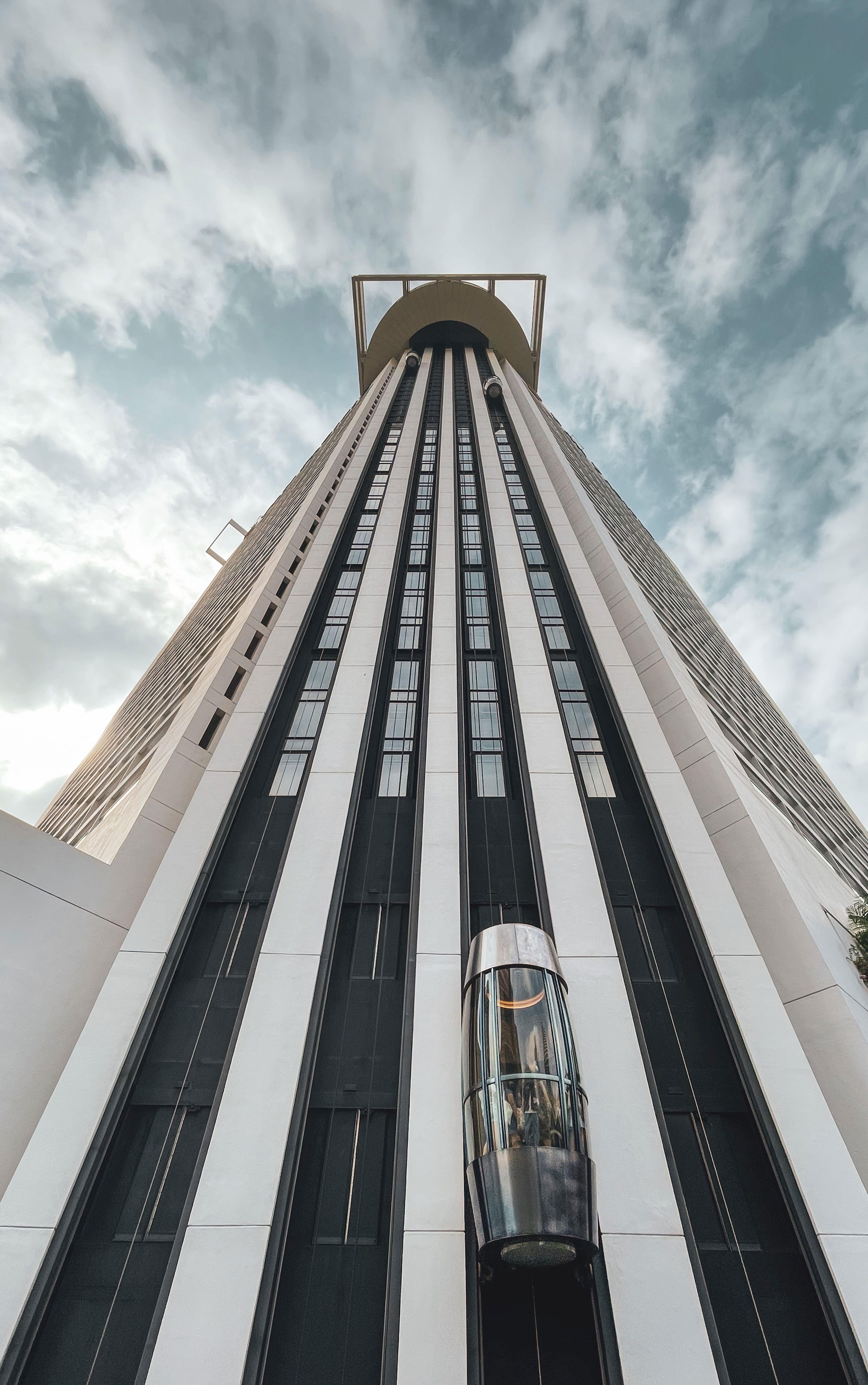 Long Building with four lanes for elevators and on three lanes elevators are in working position.