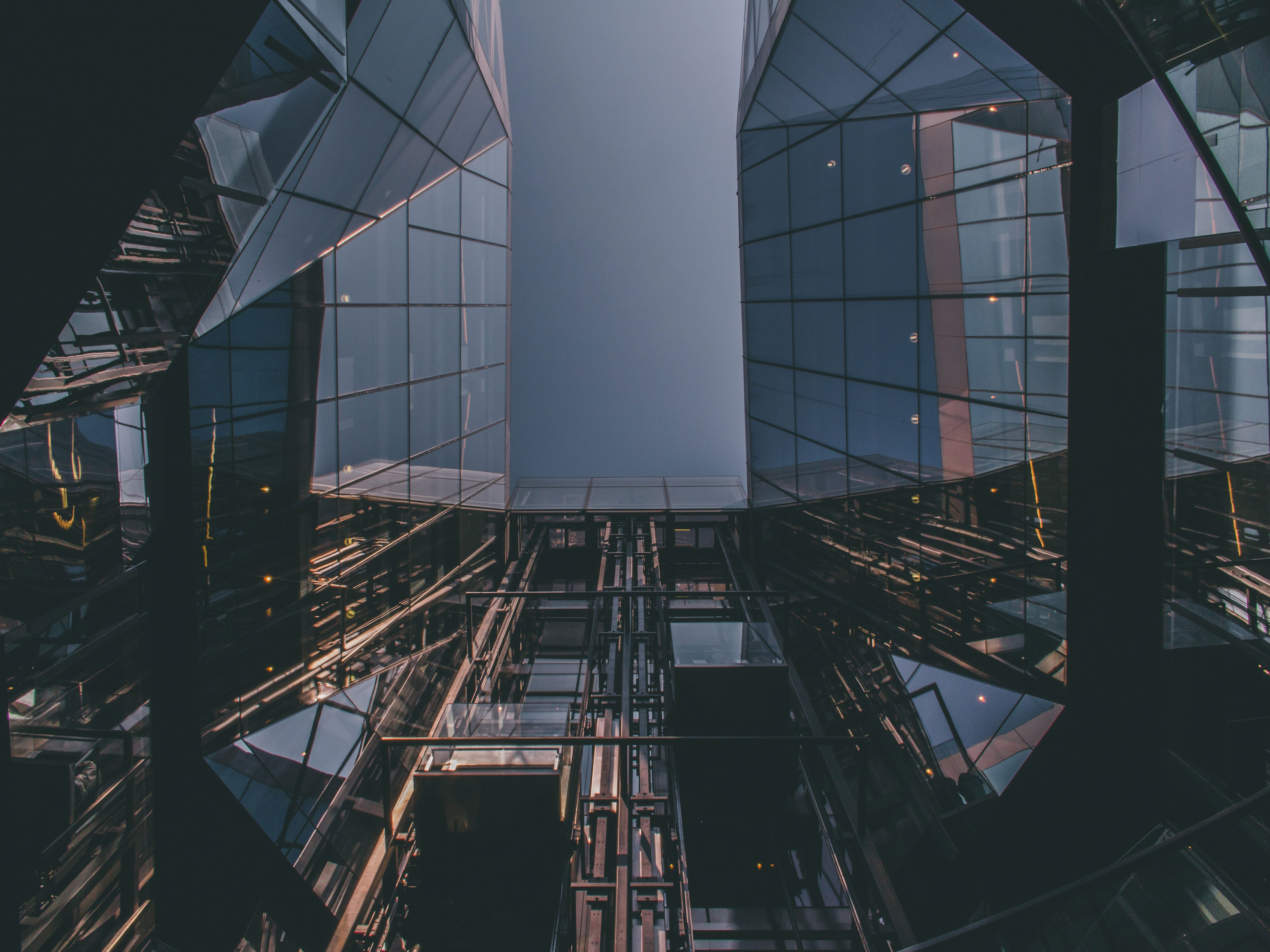 Rosh Elevators lifts in a glass building and on left and right are also build with glass.