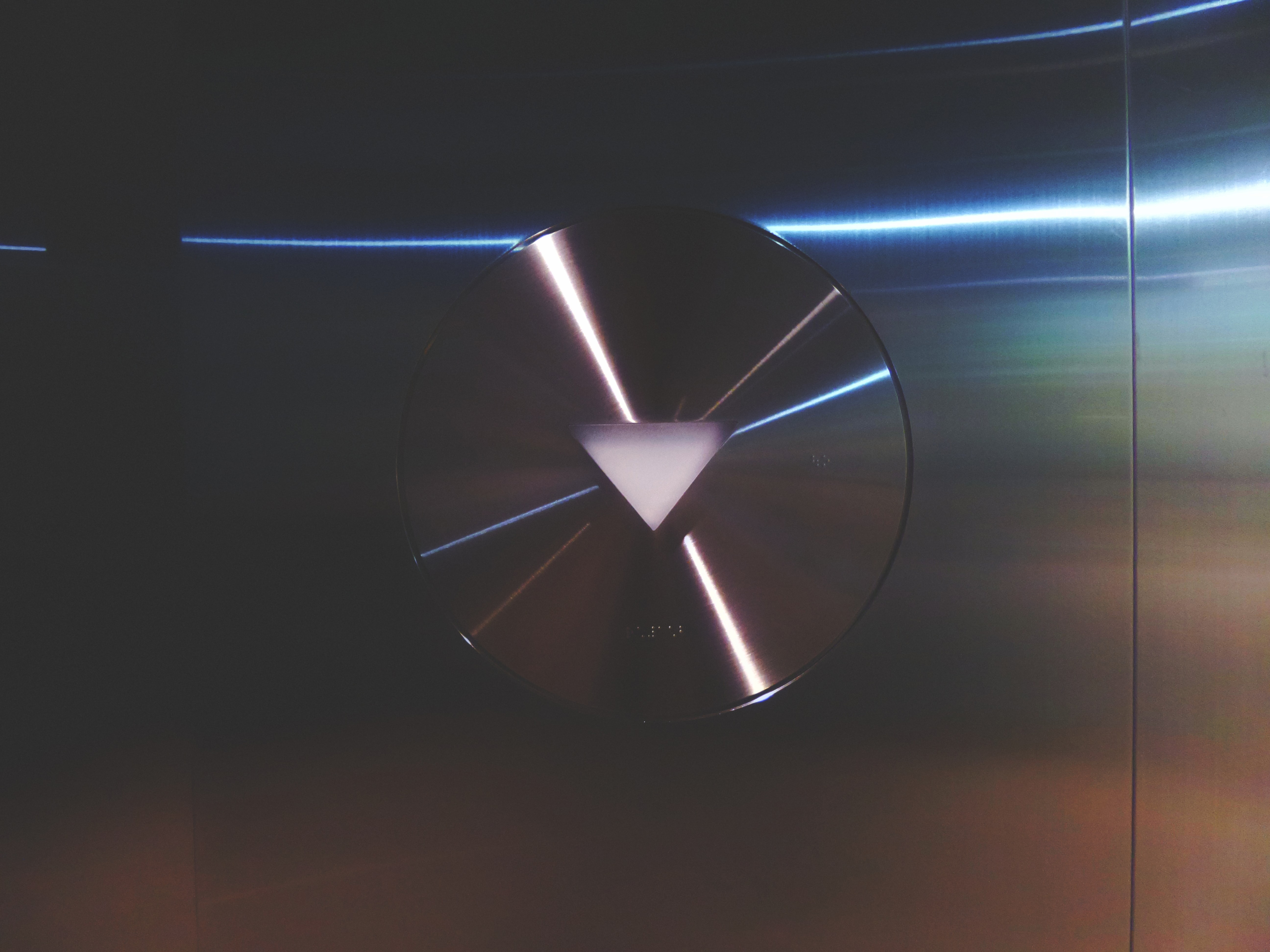 Circle with a triangle inside it build on a steel door of the lift.