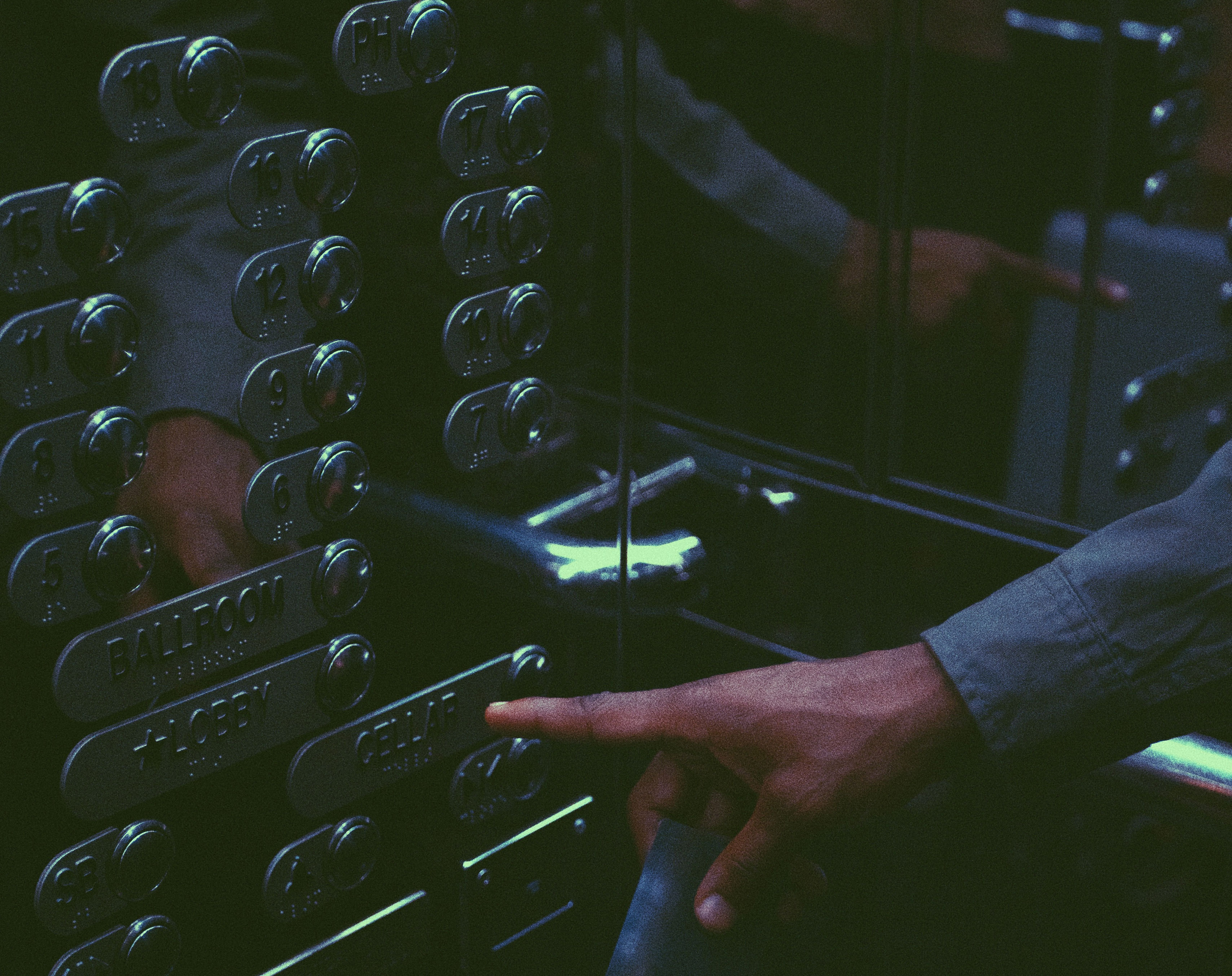 Man pressing the button cellar from all the other buttons of the Rosh Elevator.
