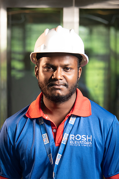 Rosh elevator worker in a uniform and a helmet.
