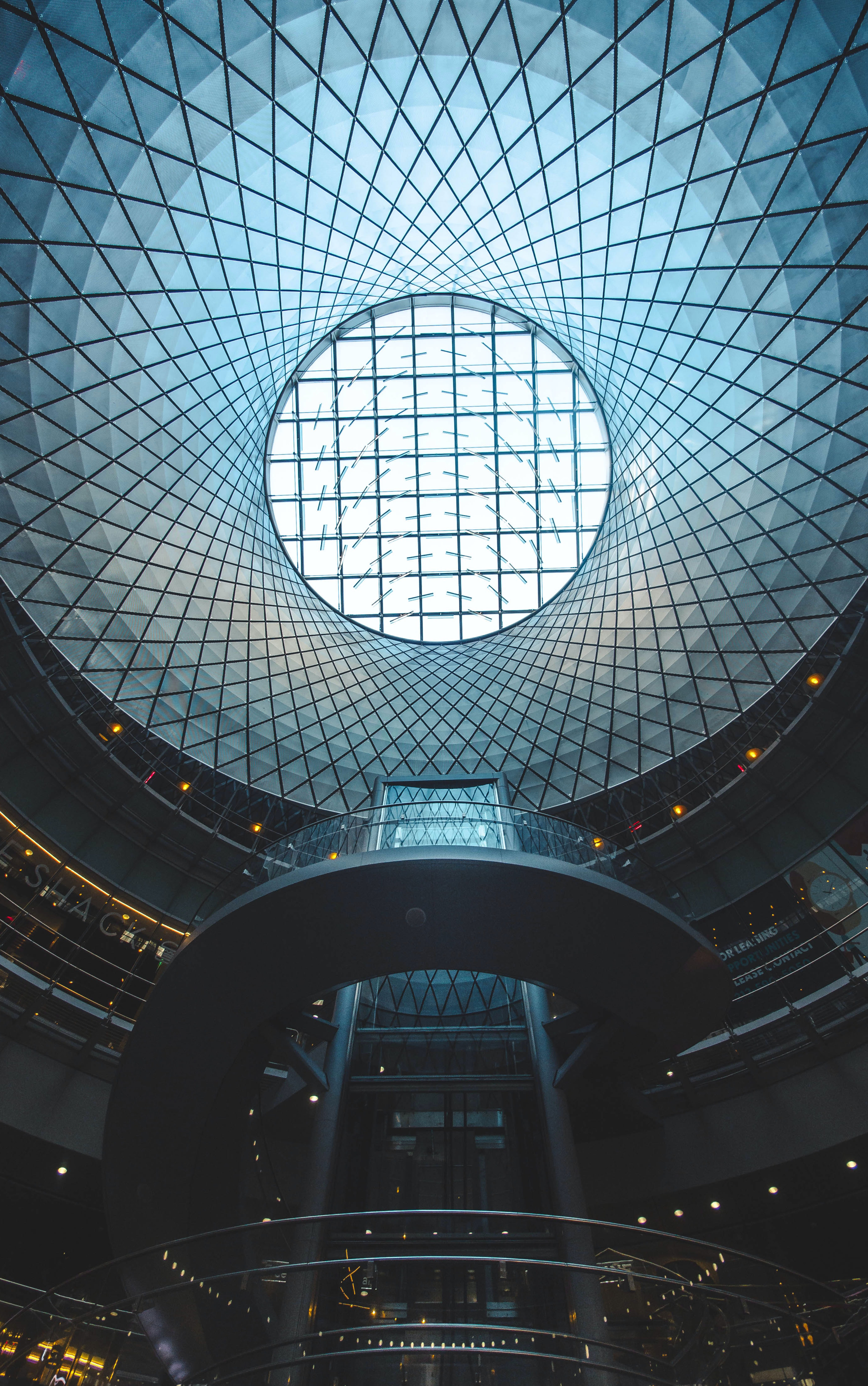 Elevator surrounded by cross going stairs and a open space on the roof.